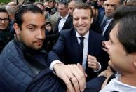 Emmanuel Macron (C), head of the political movement En Marche !, or Onwards !, and candidate for the 2017 presidential election, flanked by Alexandre Benalla (L), head of security, attends a campaign visit in Rodez, France, May 5, 2017. Picture taken May 5, 2017 . REUTERS/Regis Duvignau