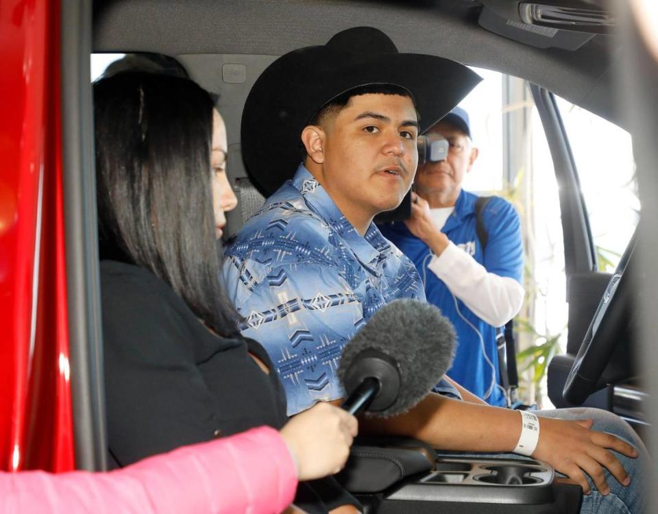 Riley Leon, 16, talks with the media at Bruce Lowrie Chevrolet in Fort Worth, Texas, Saturday, March 26, 2022. Leon received a new Chevrolet Silverado after the one he was driving was totaled in a tornado.