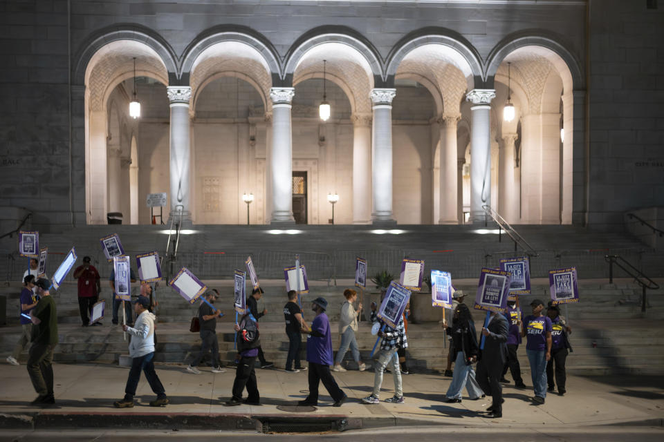 Los Angeles city employees with SEIU Local 721 picket outside of City Hall in Los Angeles on Tuesday, Aug. 8, 2023. Thousands of Los Angeles city employees, including sanitation workers, engineers and traffic officers, walked off the job for a 24-hour strike alleging unfair labor practices. The union said its members voted to authorize the walkout because the city has failed to bargain in good faith and also engaged in labor practices that restricted employee and union rights. (David Crane/The Orange County Register via AP)