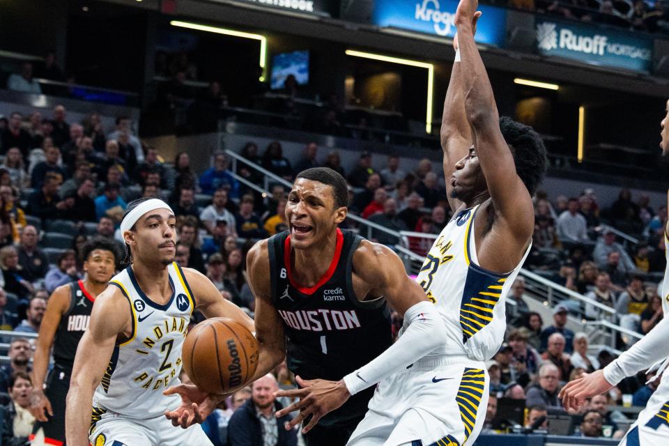 Mar 9, 2023; Indianapolis, Indiana, USA; Houston Rockets forward Jabari Smith Jr. (1) shoots the ball while Indiana Pacers forward Aaron Nesmith (23) and guard Andrew Nembhard (2) defend in the second half at Gainbridge Fieldhouse. Mandatory Credit: Trevor Ruszkowski-USA TODAY Sports