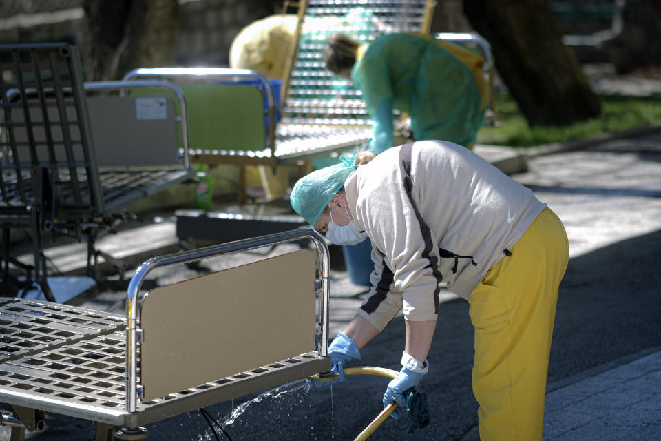 Medical staff disinfect beds at the General Hospital in Sarajevo, Bosnia, Tuesday, April 7, 2020. Less than three weeks ago, the respected Bosnian epidemiologist Sefik Pasagic was fielding calls from journalists seeking his opinion and advice on how best to prepare for the coronavirus outbreak. The 60-year-old father of four died of complications from the COVID-19 infection which his wife describes as an unnecessarily long and desperate struggle to get the help he needed.(AP Photo/Kemal Softic)