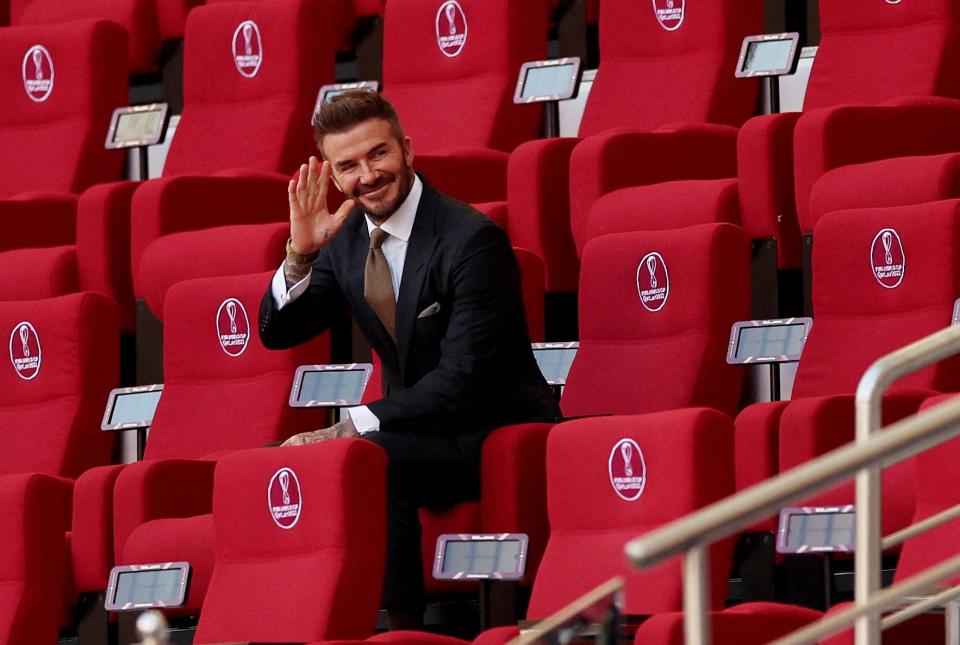David Beckham waves from the seats ahead of a match at the 2022 Qatar World Cup.