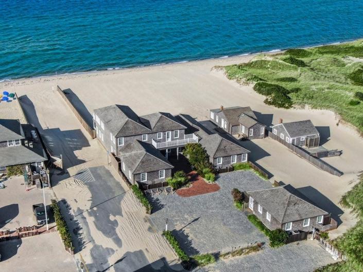 a waterfront compound of gray homes on the beach in Nantucket, Massachusetts
