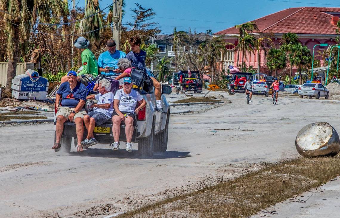 Residents are transported by rescue personnel along Estero Boulevard with suitcases as they leave the Fort Myers Beach Island, two days after Hurricane Ian hit Florida’s west coast as a Category 4 storm, on Friday September 30, 2022.