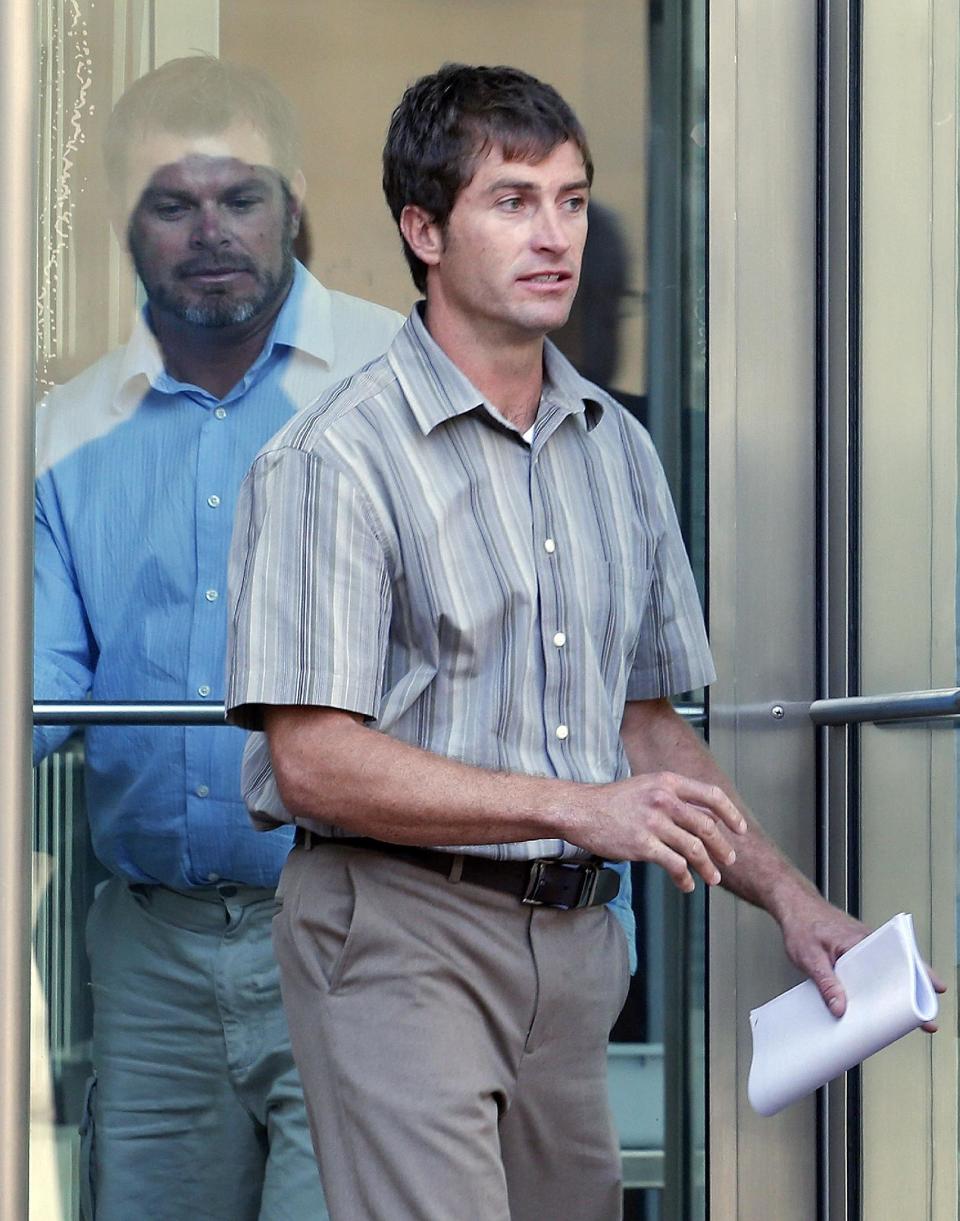 File- This Sept. 26, 2013 file photo shows Ryan Jensen, 33, front, and brother Eric Jensen, 37, leaving the federal courthouse in Denver. The two Colorado cantaloupe farmers who pleaded guilty to charges related to a deadly listeria outbreak are meeting Tuesday, Nov. 19, 2013, with some of the family members of people who got sick or died, an attorney and one of the relatives said. (AP Photo/Ed Andrieski, File)