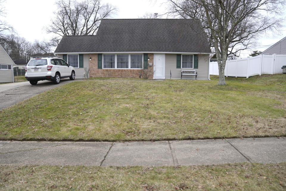 A vehicle is parked in the driveway of a home that was a scene of a murder in Levittown, Pa., on Wednesday, Jan. 31, 2024. A man has been charged with first-degree murder and abusing a corpse after his father was found decapitated. Police are investigating a video on social media that allegedly shows him holding up the head. The father was found beheaded in the bathroom of his home in Levittown, on Tuesday night. (AP Photo/Matt Rourke)