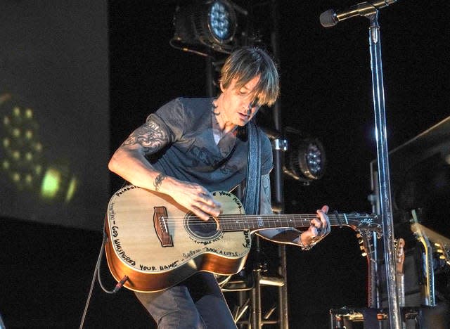 This image released by Guitar Monkey Entertainment shows Keith Urban performing for first responders at the Stardust Drive In Theatre in Watertown, Tenn., on Thursday. The private show was set up exclusively for more than 200 doctors, nurses, emergency medical technicians and staff from Vanderbilt Health, part of Vanderbilt University Medical Center.