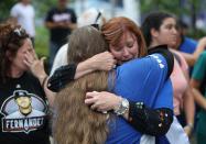 <p>People react after watching the hearse carrying Miami Marlins pitcher Jose Fernandez pass in front of the Marlins baseball stadium on September 28, 2016 in Miami, Florida. Mr. Fernandez was killed in a weekend boat crash in Miami Beach along with two friends. (Photo by Joe Raedle/Getty Images) </p>