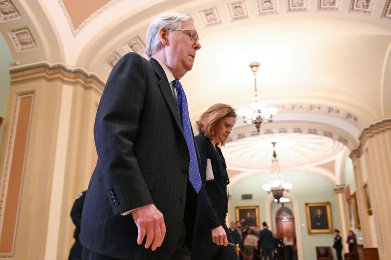 Senate Majority Leader Mitch McConnell exits the Senate chamber during a break in the impeachment trial of President Trump
