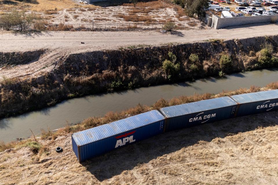 Shipping containers are used as a makeshift border wall along the U.S.-Mexico border near Downtown El Paso on Saturday.