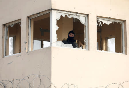 An Afghan guard looks out from a security tower at the site of a car bomb blast in Kabul, Afghanistan January 15, 2019.REUTERS/Mohammad Ismail