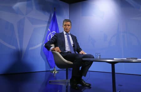 NATO Secretary General Anders Fogh Rasmussen waits before an interview with Reuters at the Alliance headquarters in Brussels August 11, 2014. REUTERS/Yves Herman