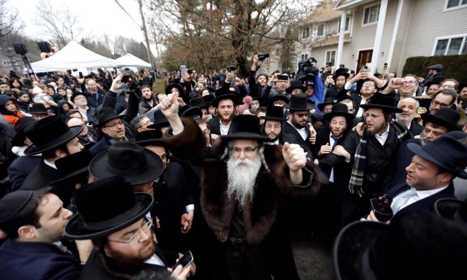 Rabbi Chaim Rottenberg leads the inauguration of a Torah scroll ceremony outside his home in Monsey, New York, on Sunday following the attack