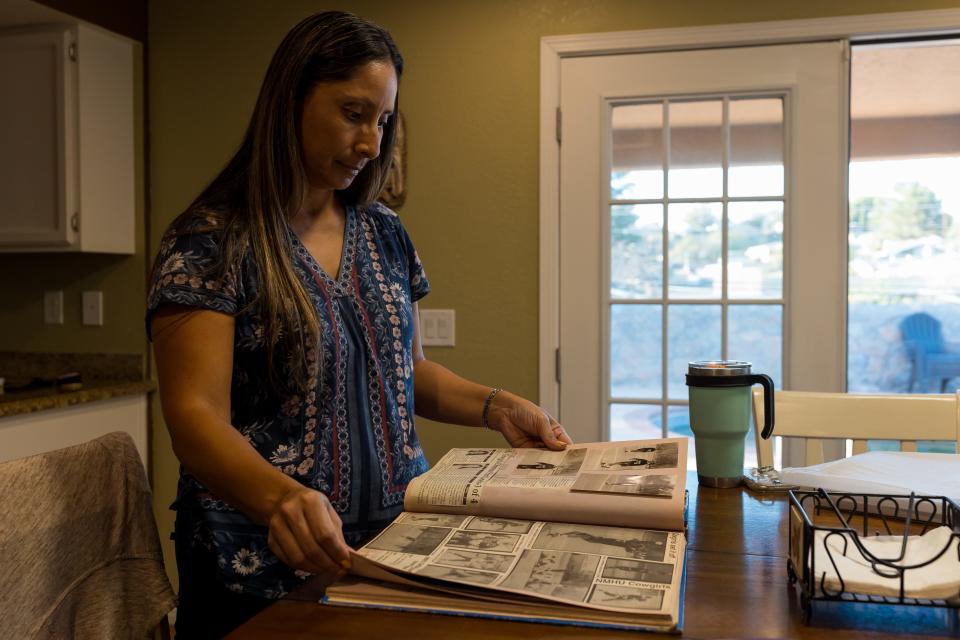 Janice Aguilar-Jaramillo, an El Paso student counselor, looks through a scrapbook of her days as a decorated pitcher at New Mexico Highlands University on Tuesday, Sept. 27, 2022, at her home in El Paso.