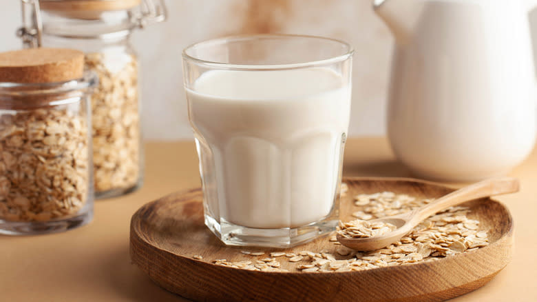 glass of milk surrounded by oats