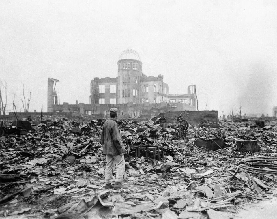 In this Sept. 8, 1945 file photo, an allied correspondent stands in the rubble of Hiroshima, Japan, a month after the first atomic bomb ever used in warfare was dropped by the U.S.