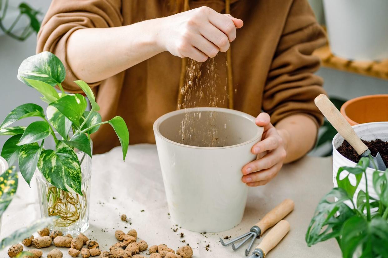 breaking up vermiculite into plant pot