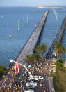 In this photo provided by the Florida Keys News Bureau, entrants in the annual Seven Mile Bridge Run approach the finish line Saturday, April 1, 2023, in Marathon, Fla. The annual event attracted 1,500 runners that traversed the longest of 42 bridges over water that help comprise the Florida Keys Overseas Highway. Joanna Stephens, 28, of Atlanta won the overall women's title and Vaclav Bursa, 15, of Big Pine Key, Fla., won the overall men's division. (Andy Newman/Florida Keys News Bureau via AP)