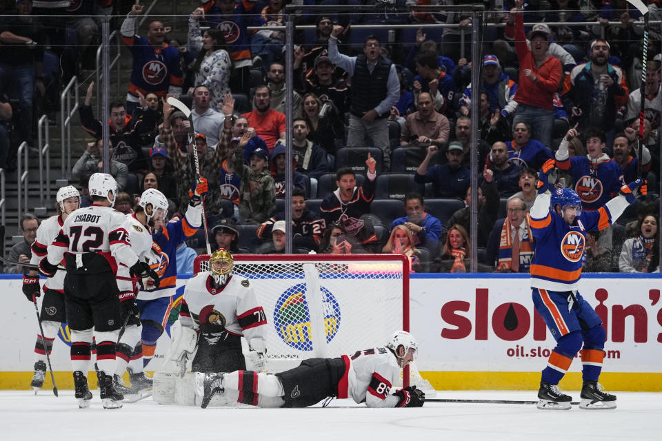 New York Islanders' Cal Clutterbuck, right, celebrates his goal on Ottawa Senators goaltender Joonas Korpisalo (70) during the first period of an NHL hockey game Thursday, Oct. 26, 2023, in Elmont, N.Y. (AP Photo/Frank Franklin II)