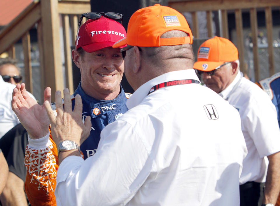 Scott Dixon, left, celebrates with his car owner Chip Ganassi after winning an IndyCar Series auto race, Sunday, July 28, 2019, at Mid-Ohio Sports Car Course in Lexington, Ohio. (AP Photo/Tom E. Puskar)