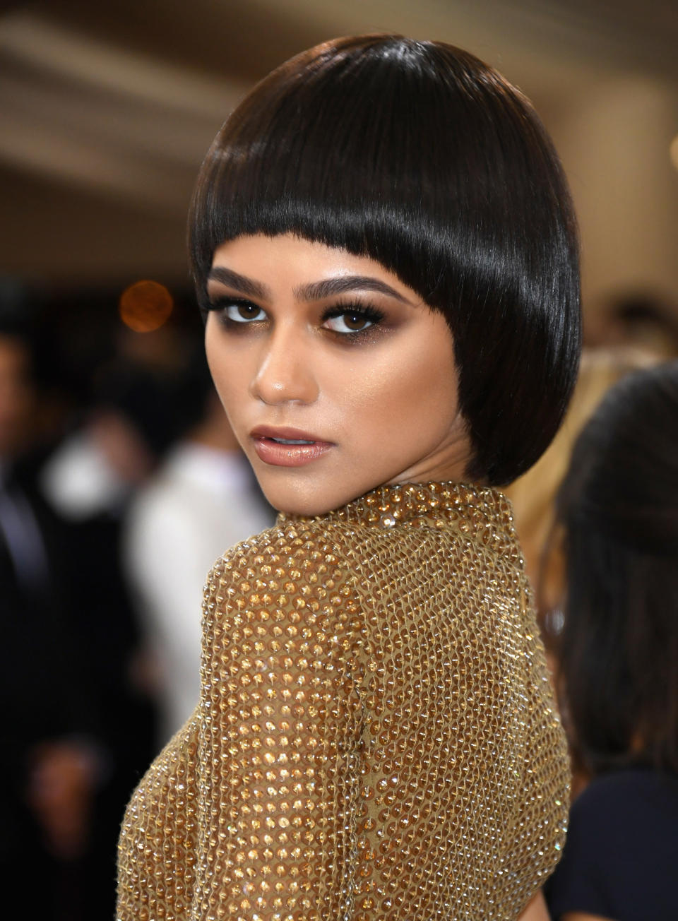 Zendaya with a short hairstyle wearing a shimmering outfit at the Met Gala