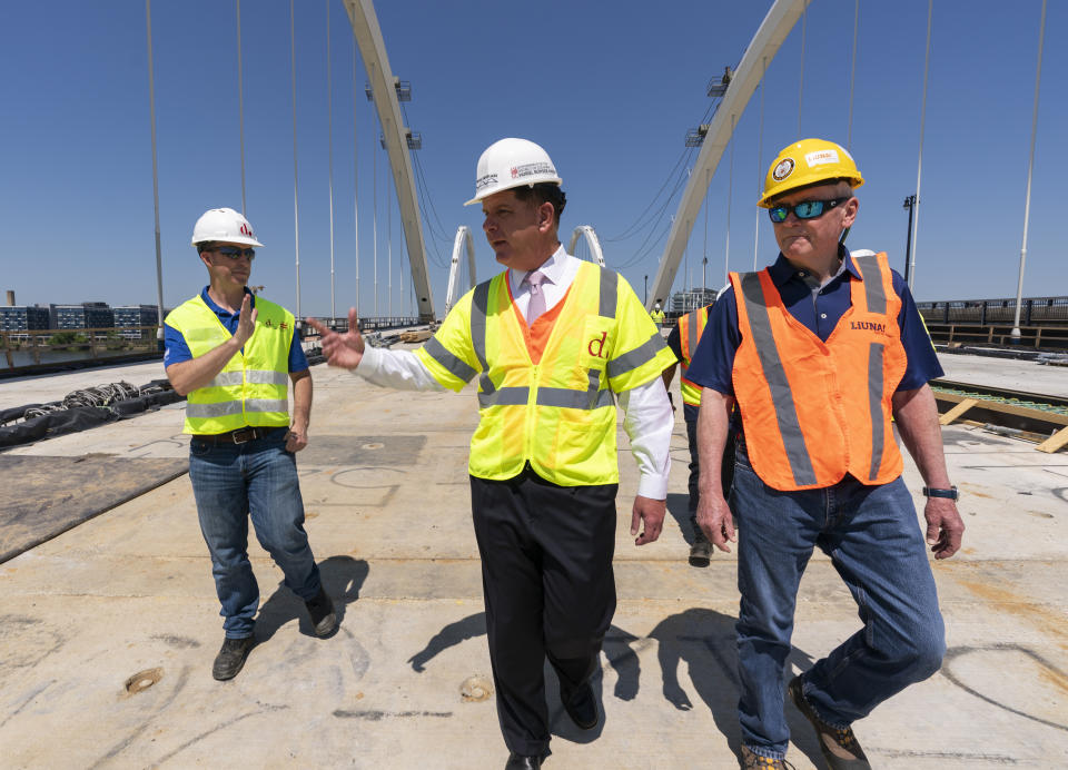Secretary of Labor Marty Walsh, center, visits the Frederick Douglass Memorial Bridge construction site together with District of Columbia Mayor Muriel Bowser and Secretary of Transportation Pete Buttigieg, in southeast Washington, Wednesday, May 19, 2021. (AP Photo/Manuel Balce Ceneta)