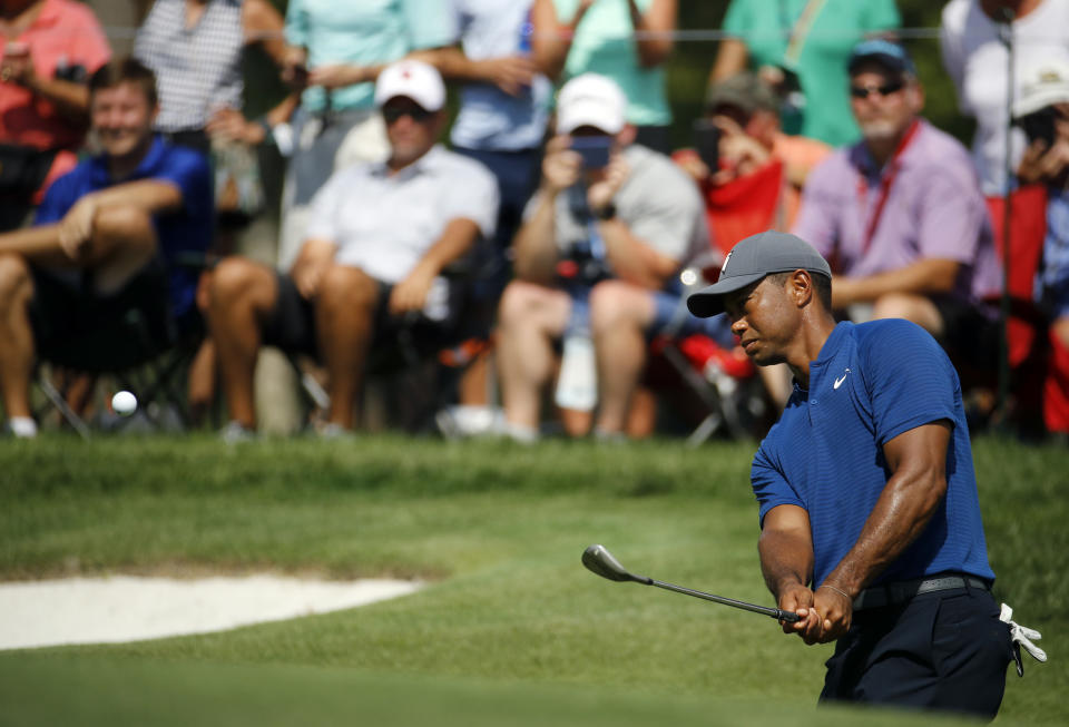 Tiger Woods hits to the 14th green during a practice round for the PGA Championship golf tournament at Bellerive Country Club, Wednesday, Aug. 8, 2018, in St. Louis. (AP Photo/Charlie Riedel)