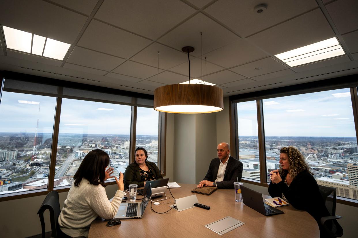 Stephanie Roy, Renee Wood, Steve Sanders, and Molly O'Brien work during a meeting at the F&G Group office at 801 Grand on Tuesday, Feb. 6, 2024, in Des Moines.