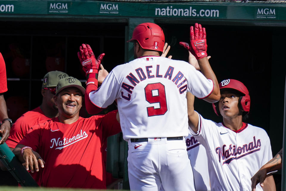 Washington Nationals' Jeimer Candelario (9) celebrates after his solo home run with manager Dave Martinez, left, and others during the fourth inning of a baseball game against the Detroit Tigers at Nationals Park, Saturday, May 20, 2023, in Washington. (AP Photo/Alex Brandon)