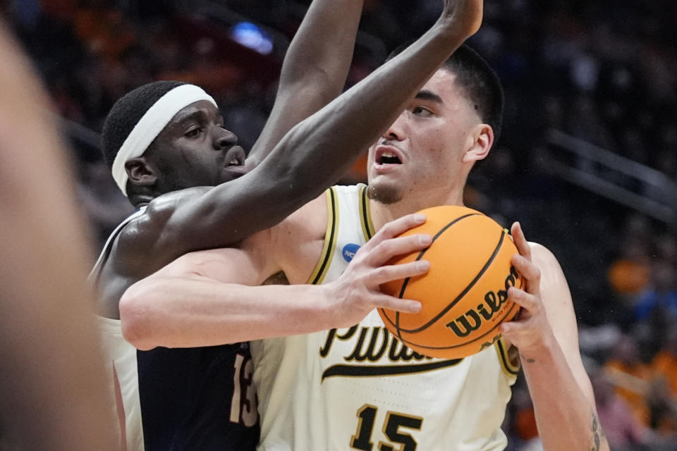 Gonzaga forward Graham Ike (13) guards Purdue center Zach Edey (15) during the second half of a Sweet 16 college basketball game in the NCAA Tournament, Friday, March 29, 2024, in Detroit. (AP Photo/Paul Sancya)