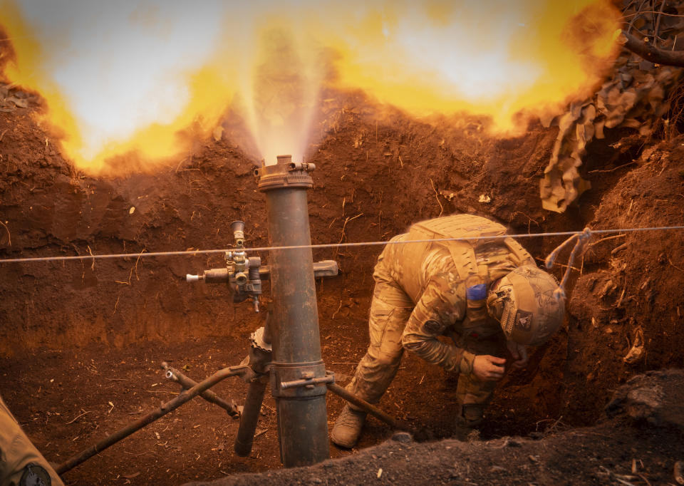 Ukrainian servicemen of the 28th Separate Mechanised Brigade fires a 122mm mortar towards Russian positions at the front line, near Bakhmut, Donetsk region, Ukraine, Sunday, March 3, 2024. (AP Photo/Efrem Lukatsky)