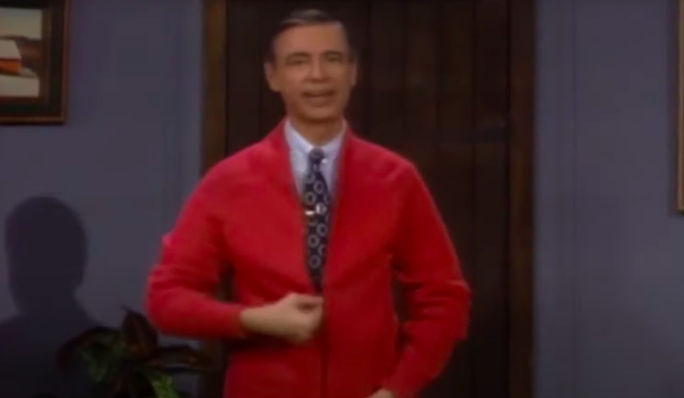 Fred Rogers wearing a red sweater on his show