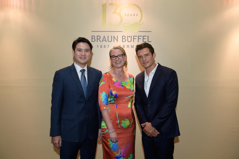 SINGAPORE ONLY – Orlando Bloom with Christiane Brunk, Managing Director and Fourth Generation Owner, Braun Büffel and Daniel Chiang, Director, Lianbee-Jeco at Braun Büffel’s 130th Year Anniversary Celebrations in Singapore. (Photo: Braun Büffel )