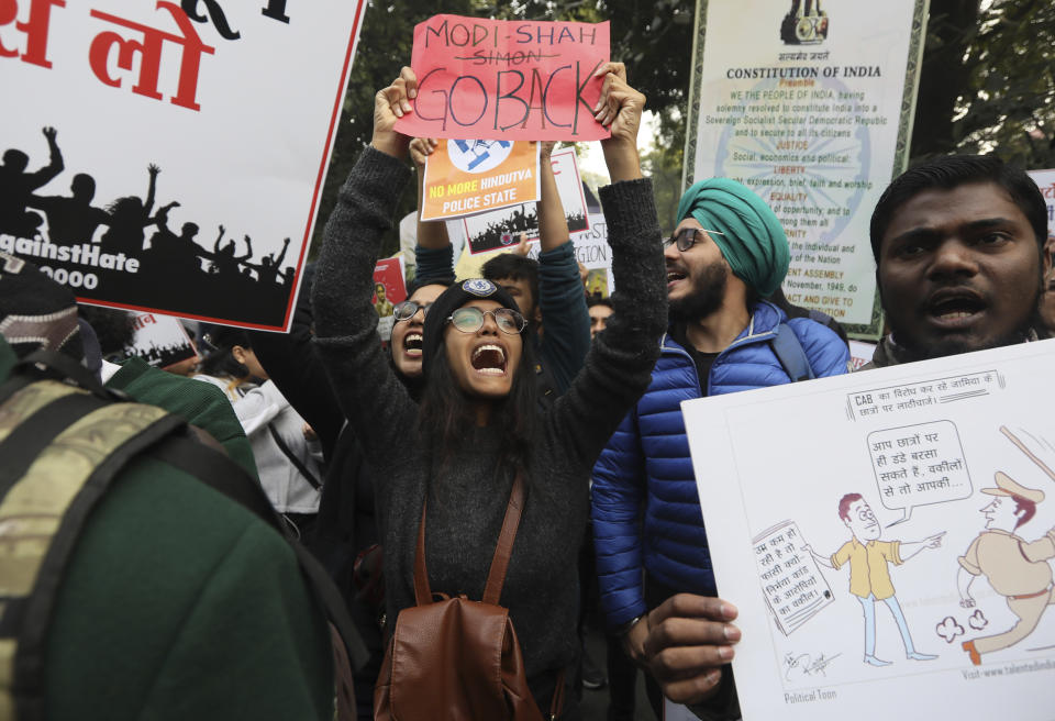 Students shout slogans against government during a protest against a new citizenship law in New Delhi, India, Tuesday, Dec. 24, 2019. Hundreds of students marched Tuesday through the streets of New Delhi to Jantar Mantar, an area designated for protests near Parliament, against the new citizenship law, that allows Hindus, Christians and other religious minorities who are in India illegally to become citizens if they can show they were persecuted because of their religion in Muslim-majority Bangladesh, Pakistan and Afghanistan. It does not apply to Muslims. (AP Photo/Manish Swarup)