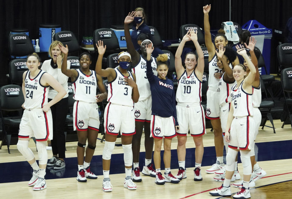 Connecticut players wave to family and friends after an NCAA college basketball game against Providence at Harry A. Gampel Pavilion, Saturday, Jan. 9, 2021, in Storrs, Conn. (David Butler II/Pool Photo via AP)