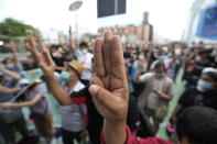 Pro-democracy supporters display the three-finger symbol of resistance during a demonstration in Bangkok, Thailand, Thursday, June 24, 2021. Pro-democracy protesters have taken to the streets of Thailand's capital, marking the 89th anniversary of the overthrow of the country's absolute monarchy by renewing their demands that the government step down, the constitution be amended and the monarchy become more accountable. (AP Photo/Sakchai Lalit)