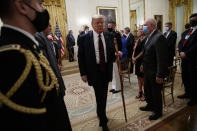 President Donald Trump departs carrying a walking stick given to him by Sen. Lamar Alexander, R-Tenn., after a signing ceremony for H.R. 1957 – "The Great American Outdoors Act," in the East Room of the White House, Tuesday, Aug. 4, 2020, in Washington. (AP Photo/Alex Brandon)