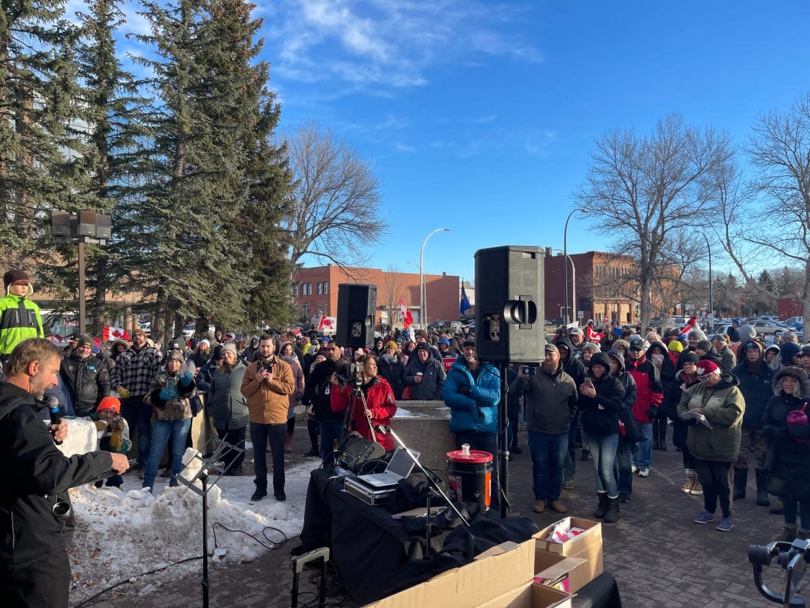 After arriving in a convoy, protesters gather outside the Lethbridge courthouse on Friday. Three of the men charged in the Coutts border blockades earlier this year had court appearances in the morning.  (Erin Collins/CBC - image credit)