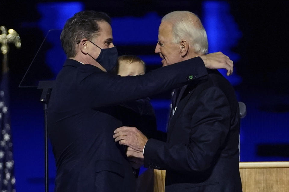 FILE - President-elect Joe Biden, right, embraces his son Hunter Biden, left, in Wilmington, Del., on Nov. 7, 2020. (AP Photo/Andrew Harnik, Pool, File)
