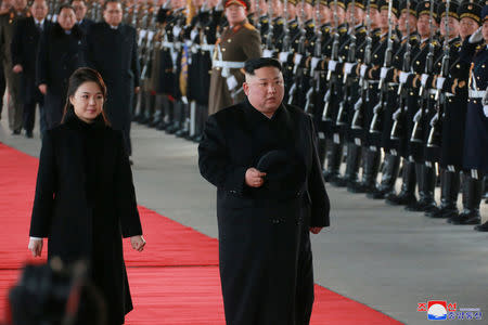 North Korean leader Kim Jong Un and wife Ri Sol Ju inspect an honour guard before leaving Pyongyang for a visit to China, this January 7, 2019 photo released by North Korea's Korean Central News Agency (KCNA) in Pyongyang January 8, 2019. KCNA via REUTERS