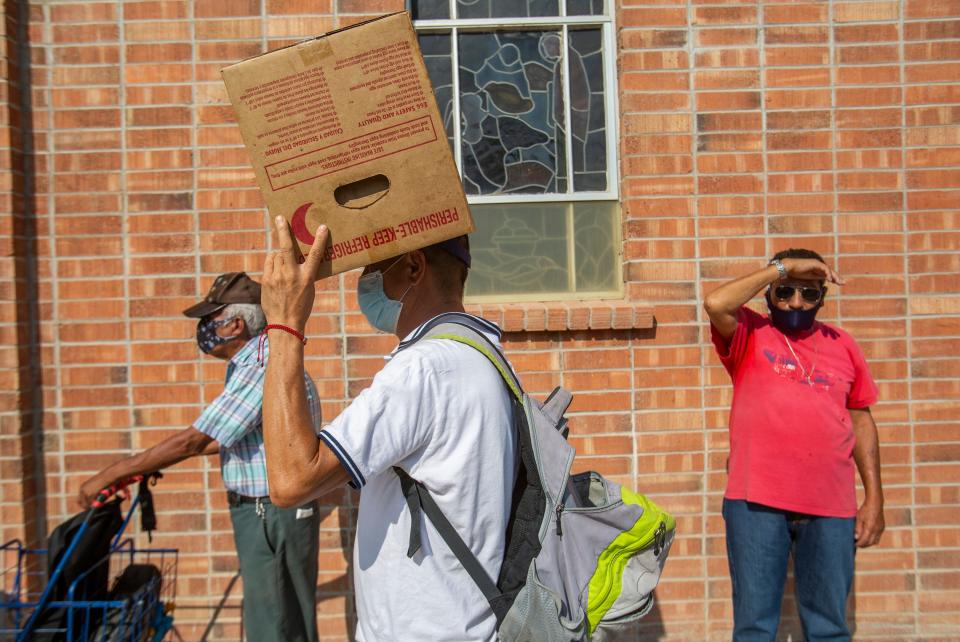 Farmworkers line up to receive food from a food bank in Calexico, Calif. Many of the farmworkers depend on donations to supplement their food source.