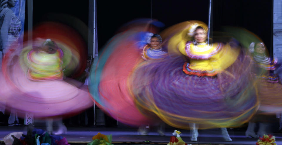 Dancers are a blur of color as they perform during Cinco de Mayo celebrations in Portland, Ore., May 5, 2015. Ballet Folklorico Mexico En La Piel performed at the annual Portland event accompanied by the band Mariachi Guadalajara from Jalisco, Mexico. (Don Ryan/AP)