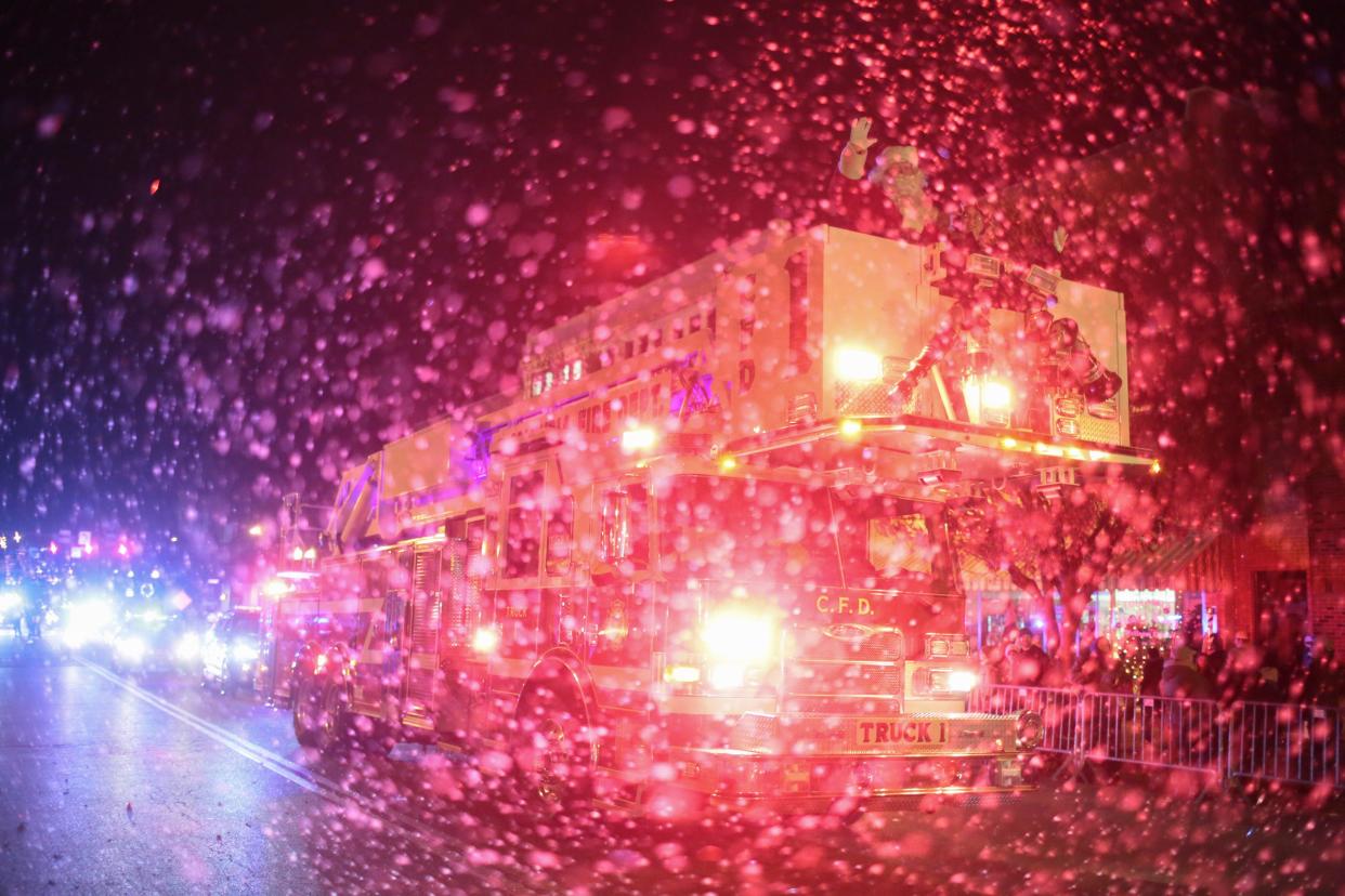 Santa Claus and Mrs. Claus ride on a Columbia Fire and Rescue engine down West 7th Street during the Columbia Main Street Christmas Parade on Monday, Dec. 2, 2019. (Staff photo by Mike Christen)