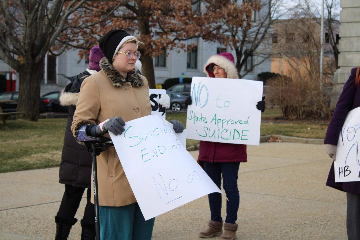 Disability justice advocate Jules Good joined other opponents of the End of Life Options Act in front of the New Hampshire Statehouse in Concord on Thursday, March 21, 2024.