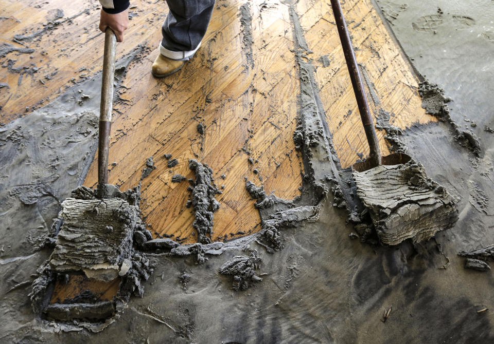 A worker shovels sand out of a living room in Longport, N.J., after it was carried in by surge from Superstorm Sandy, on Nov. 2, 2012. (Patrick Semansky / AP file)