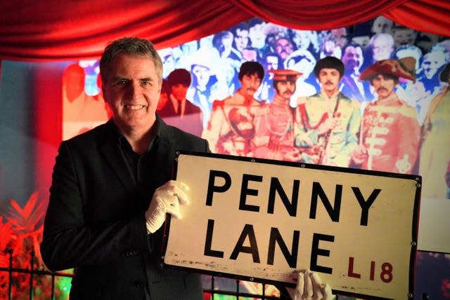 Mayor of Liverpool City Region Steve Rotheram holding the now returned Penny Lane street sign