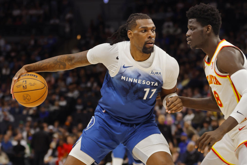 Minnesota Timberwolves center Naz Reid (11) works around Atlanta Hawks forward Mouhamed Gueye during the first quarter of an NBA basketball game Friday, April 12, 2024, in Minneapolis. (AP Photo/Bruce Kluckhohn)