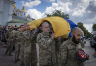 Ukrainian soldiers carry the coffin of a soldier, codename Fanat, killed by the Russian troops in a battle, during his funeral at St Michael cathedral in Kyiv, Ukraine, Ukraine, Monday, July 18, 2022. (AP Photo/Efrem Lukatsky)