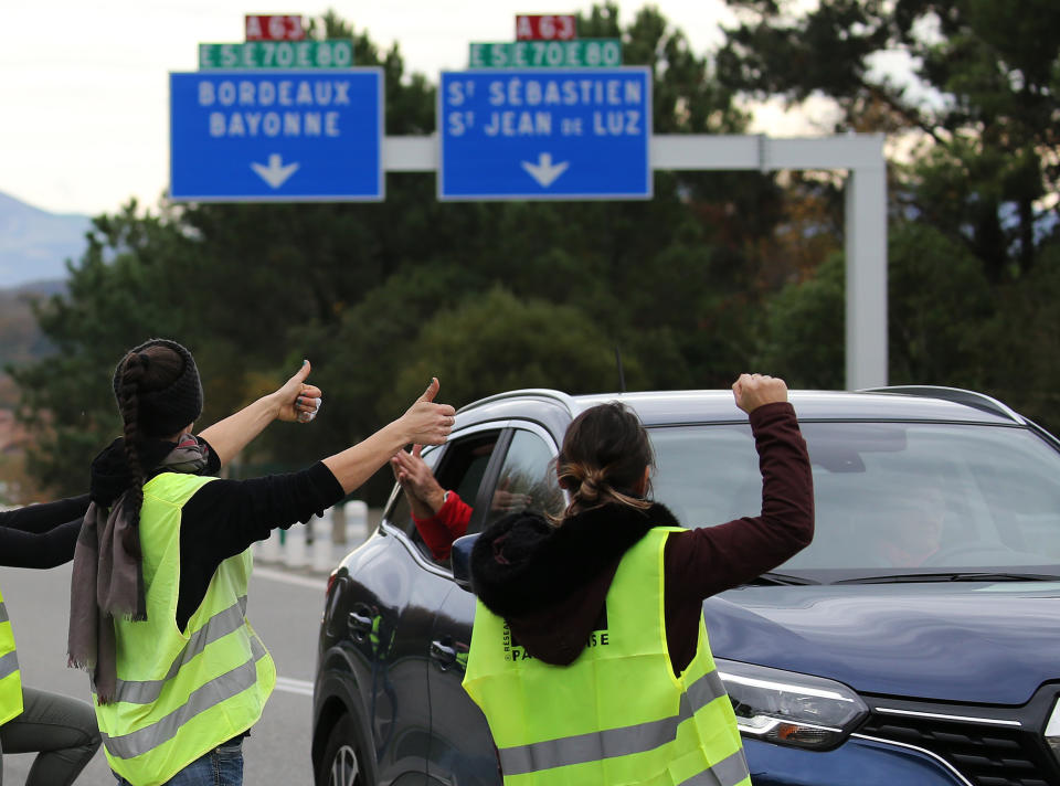 Demonstrators open the toll gates on motorway near Biarritz, southwestern France, Monday, Dec. 3, 2018. French Prime Minister Edouard Philippe is holding crisis talks with representatives of major political parties in the wake of violent anti-government protests that have rocked Paris. The "yellow vest" movement is bringing together people from across the political spectrum complaining about France's economic inequalities and waning spending power. (AP Photo/Bob Edme)