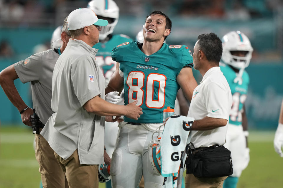 Miami Dolphins tight end Tanner Conner (80) is assisted on the field during the second half of a pre season NFL football game against the Atlanta Falcons, Friday, Aug. 9, 2024, in Miami Gardens, Fla. (AP Photo/Wilfredo Lee)